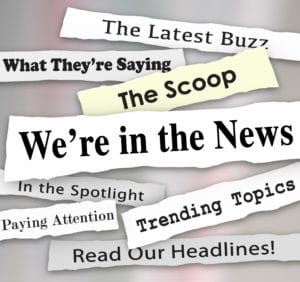 We're in the News words on newspaper headlines with other phrases like Paying attention, the latest buzz, scoop, trending topics, in the spotlight and more