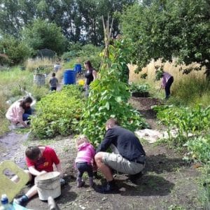 community volunteers and children working in Welsh House Farm Green Grafters garden