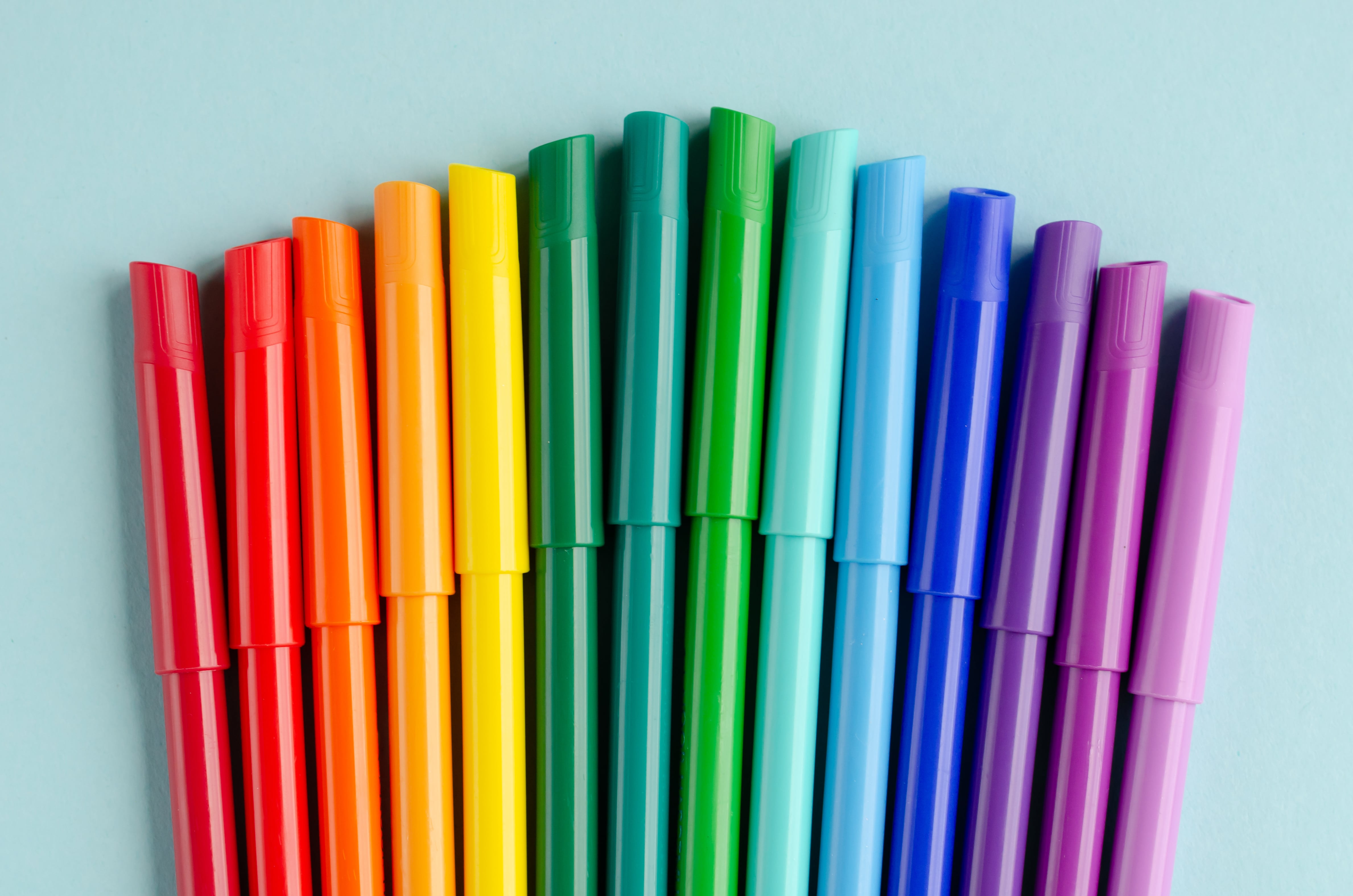 Colored felt tip pens composition on blue background. Flat lay, layout and tabletop mockup with copy space.