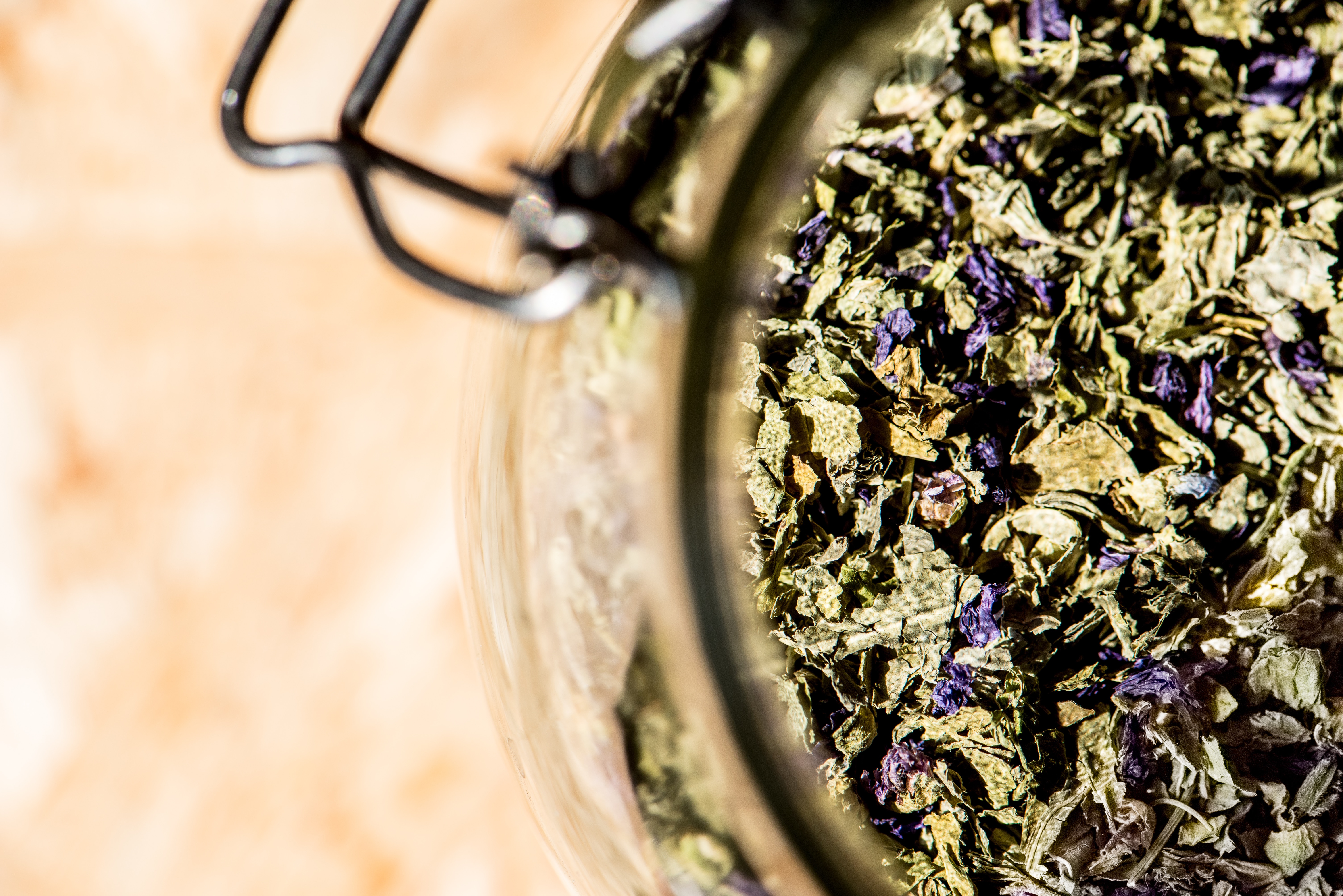 glass jar full of mallow, leaves and flowers for healthy infusion, mallow tea