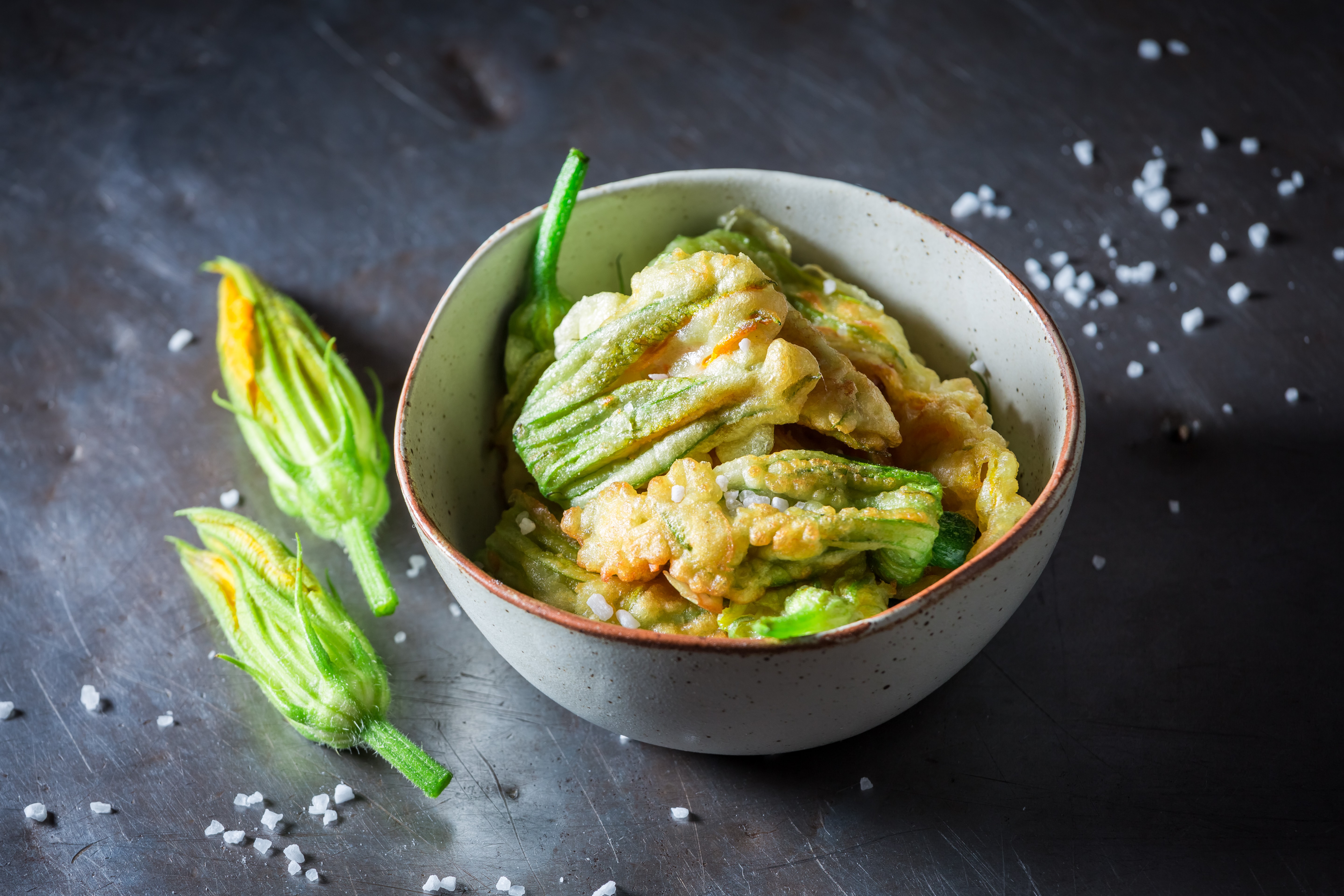 Homemade and tasty roasted zucchini flower served with salt