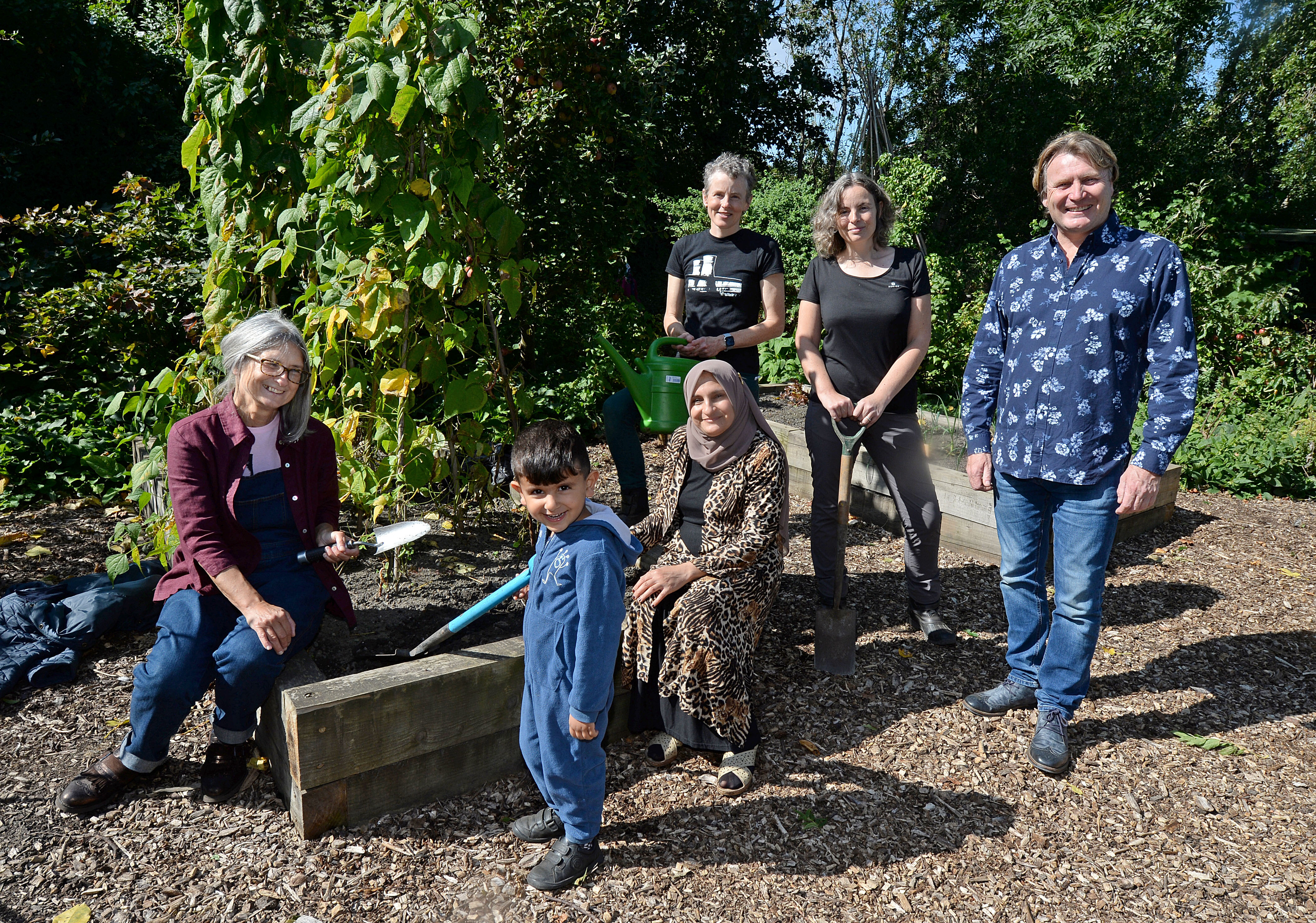 Gardener David Domoney with (L to R): Sheila Sutherland, Ravyer Osman, Rezan Mohamed, Jess Banham and Jacqui Dace at the Tinsley Community Allotment in Sheffield, South Yorkshire, which has won a 'Cultivation Street' award - a competition run by celebrity gardener, David Domoney.