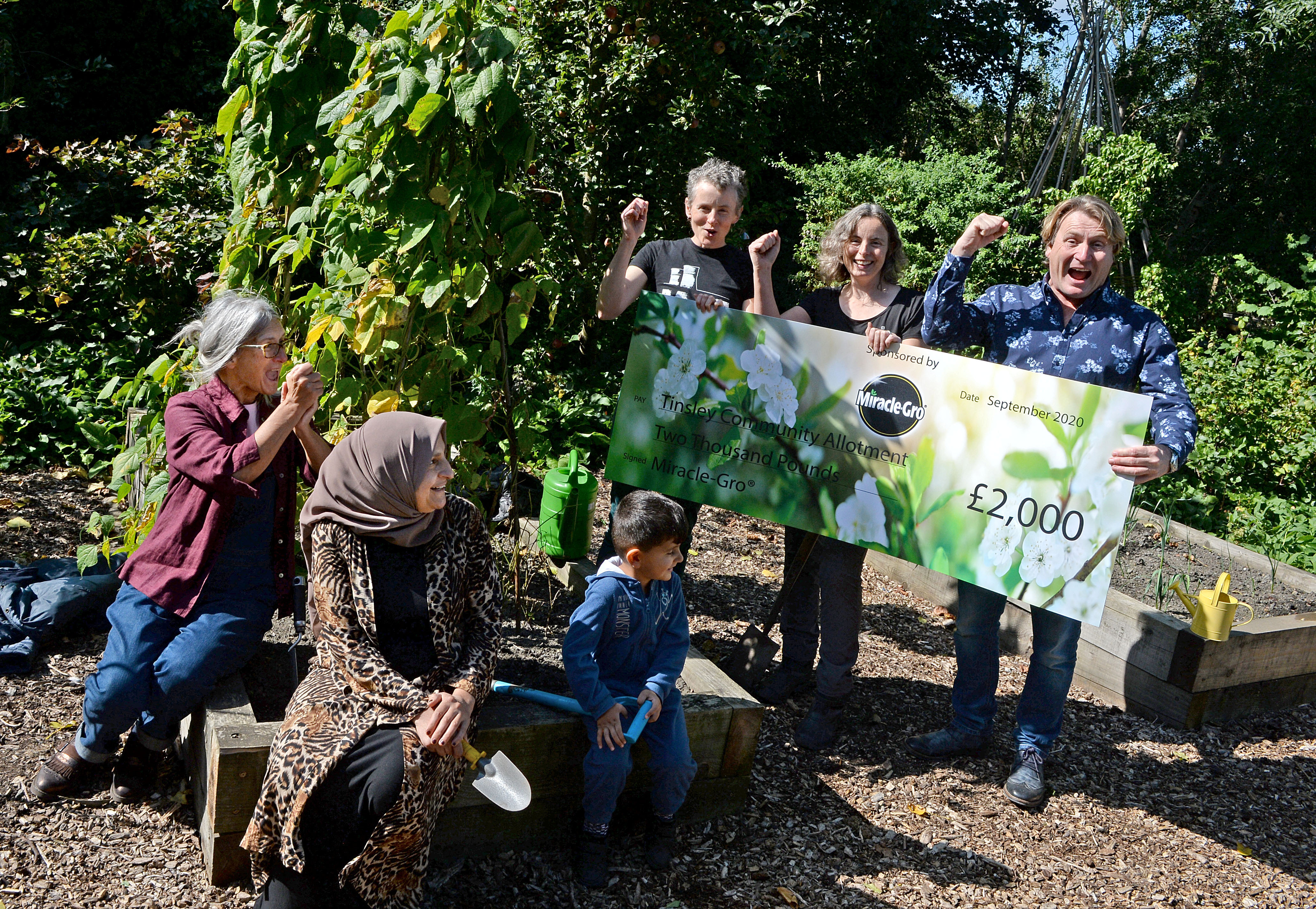 Gardener David Domoney with (L to R): Sheila Sutherland, Ravyer Osman, Rezan Mohamed, Jess Banham and Jacqui Dace at the Tinsley Community Allotment in Sheffield, South Yorkshire, which has won a 'Cultivation Street' award - a competition run by celebrity gardener, David Domoney.