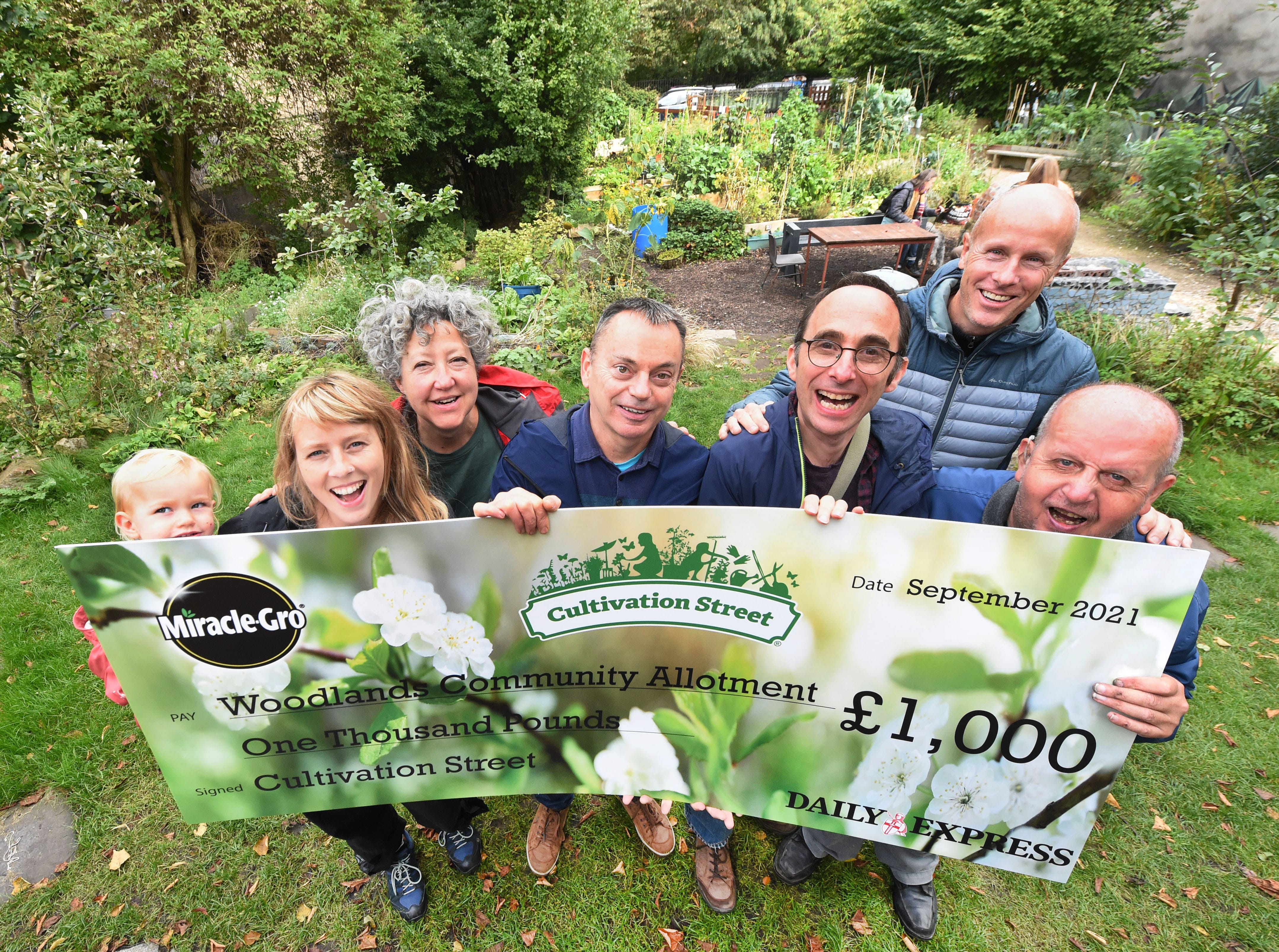 D.EXPRESS: Tim Cowen and locals at the Woodlands Community Garden, Ashley Street, Glasgow, who have won the £1,000 Community Garden category in the Cultivation Street gardening competition with David Domoney and Miracle-Grow.