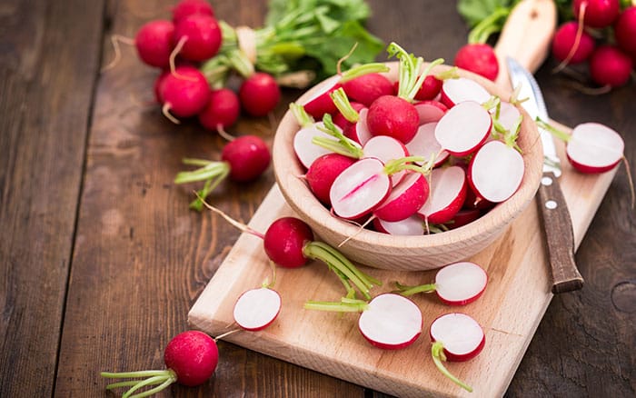 Sliced radish being made into a salad