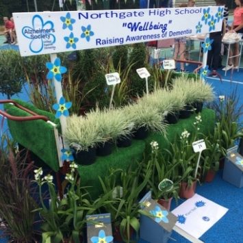 Northgate High School well being plant stall, sign reading "Raising Awareness of Dementia"